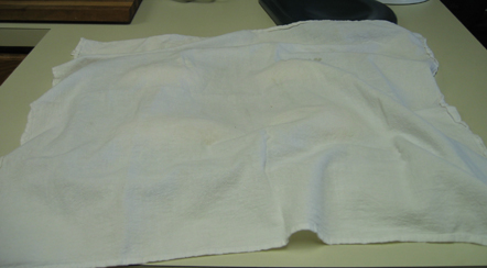 Tea Towel covering rising loaves of bread.